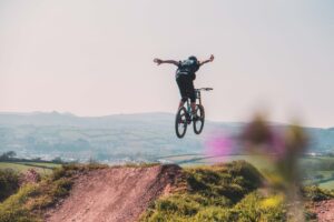 man mountain biking off jump
