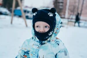 kid bundled up in jacket and hat